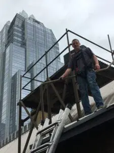 A man standing on top of a building.